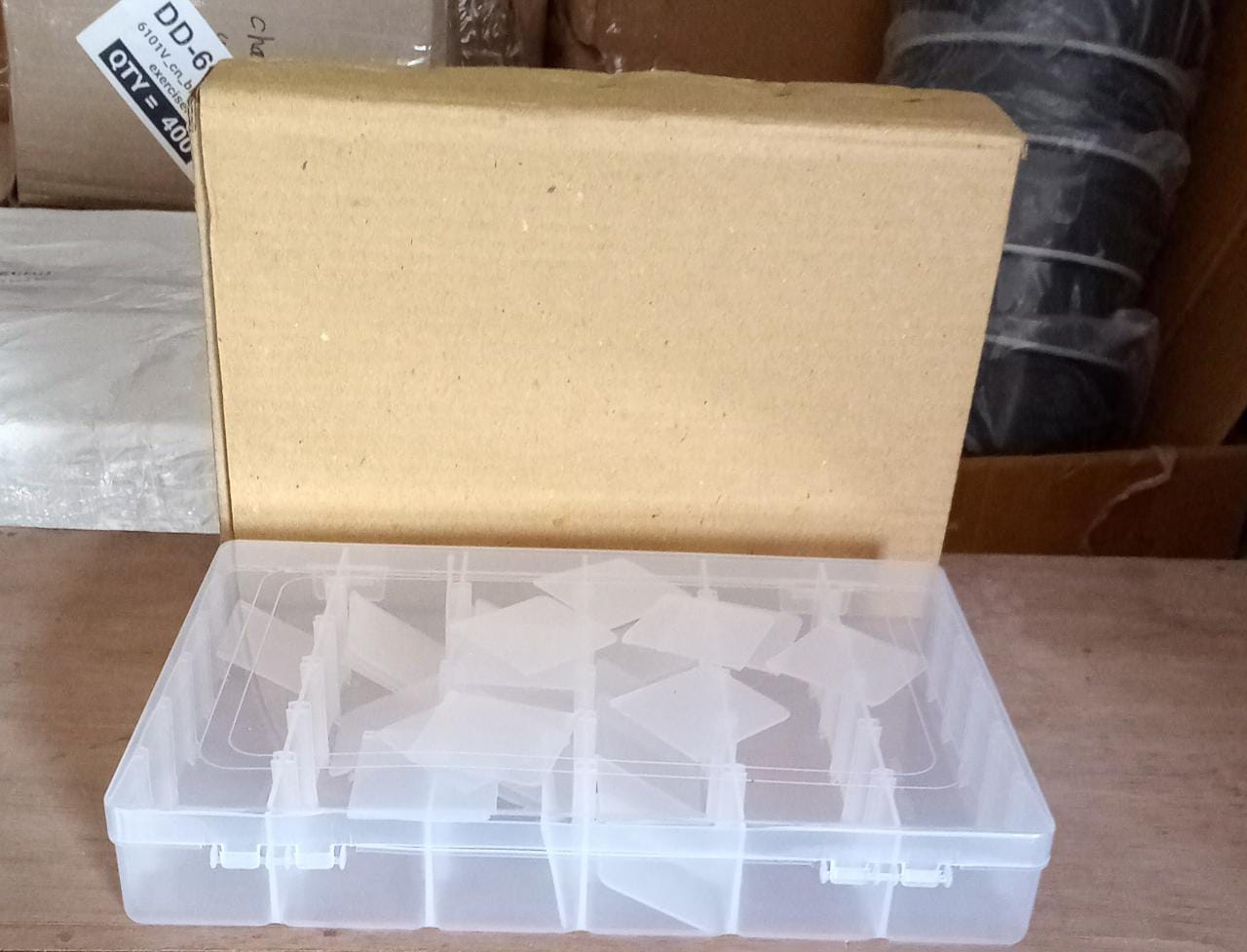 Empty clear plastic organizer box with adjustable dividers for various items.
