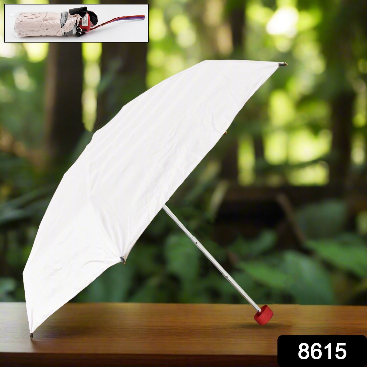 A white umbrella with a red handle is open on a wooden table, with a small inset showing it folded.